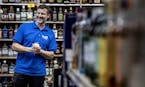 Isanti Liquor store manager John Jacobi enjoyed a lighthearted moment with coworkers.