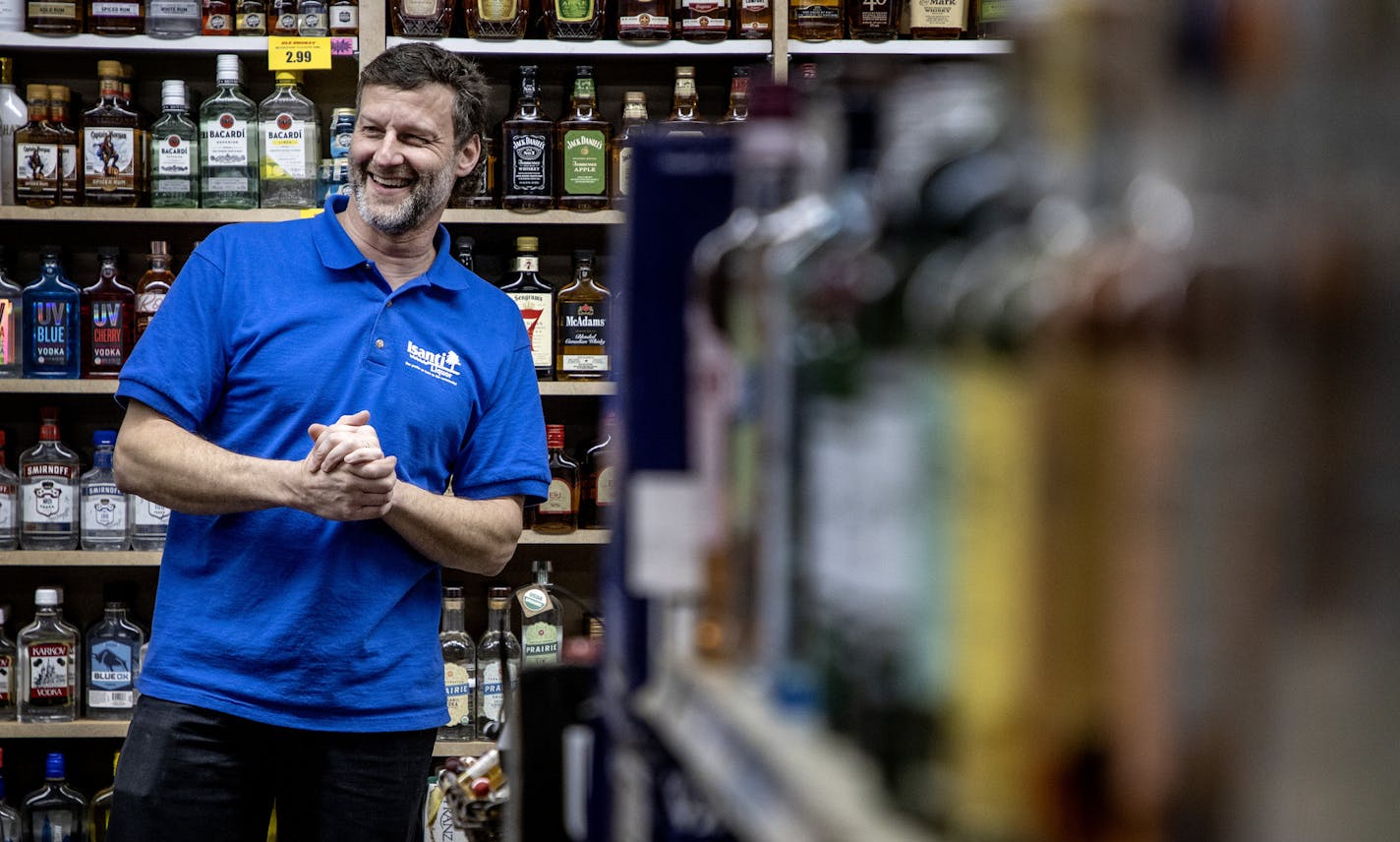 Isanti Liquor store manager John Jacobi enjoyed a lighthearted moment with coworkers.