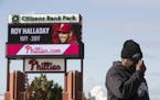 Michael Aikens crosses himself as he pays his respects outside Citizens Bank Park at a makeshift memorial for former Phillies pitcher Roy Halladay in 