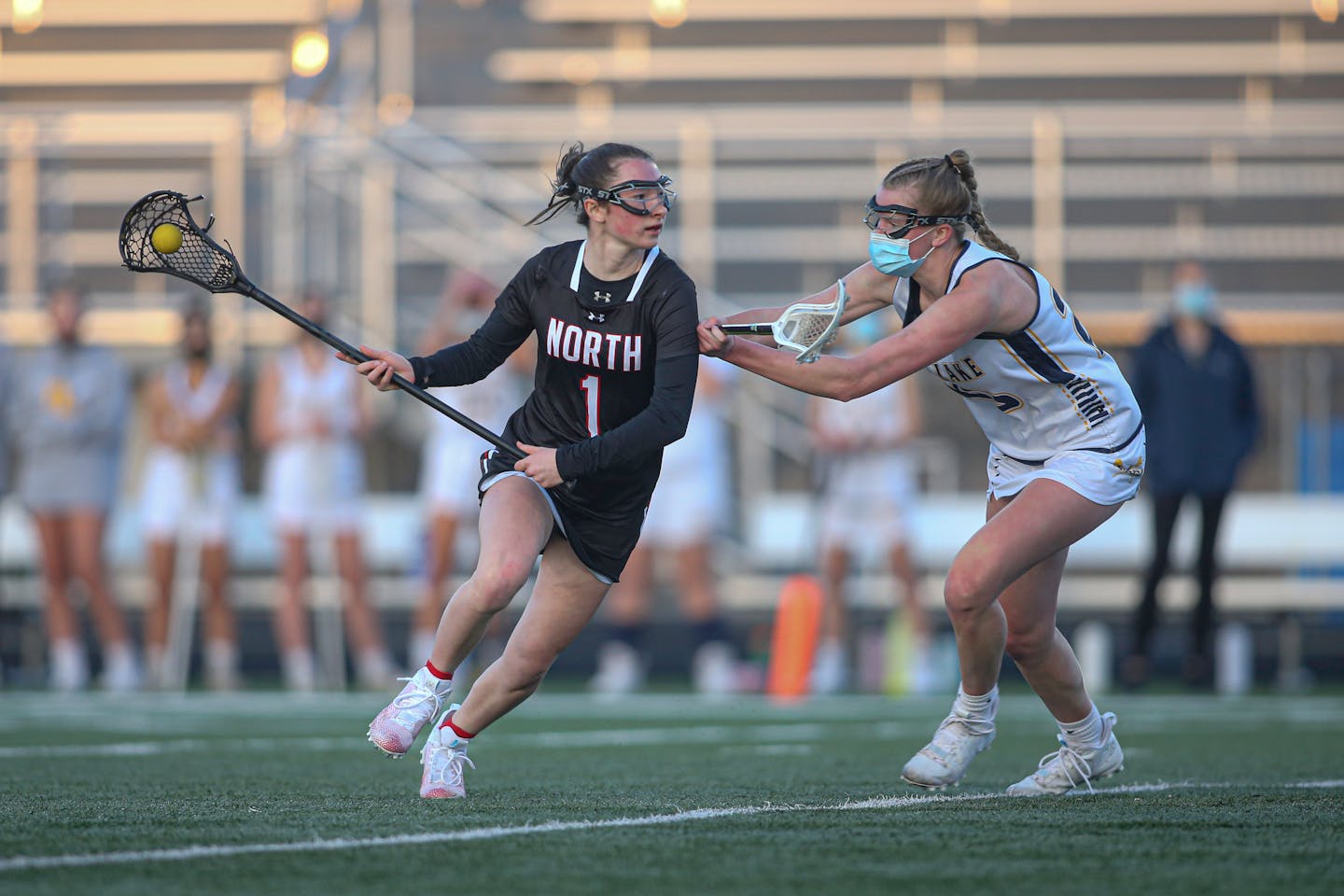 Lakers senior Payton Bloedow (right) puts pressure on Lakeville North's Alex Ward (1) in an April 21, 2021, game at Prior Lake. Bloedow was a member of the Prior Lake team that won the last state girls' lacrosse tournament in 2019 and she will attempt to help her team defend that title in 2021.