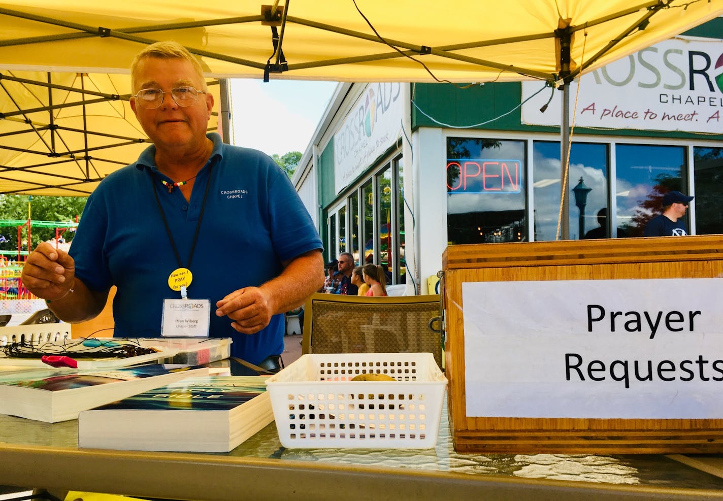 Dean Wiberg staffs the table offering free Bibles and prayer requests at the Crossroads Ministries chapel at the Minnesota State Fair. Crossroads offers three Sunday services, as well as weeklong activities and entertainment.