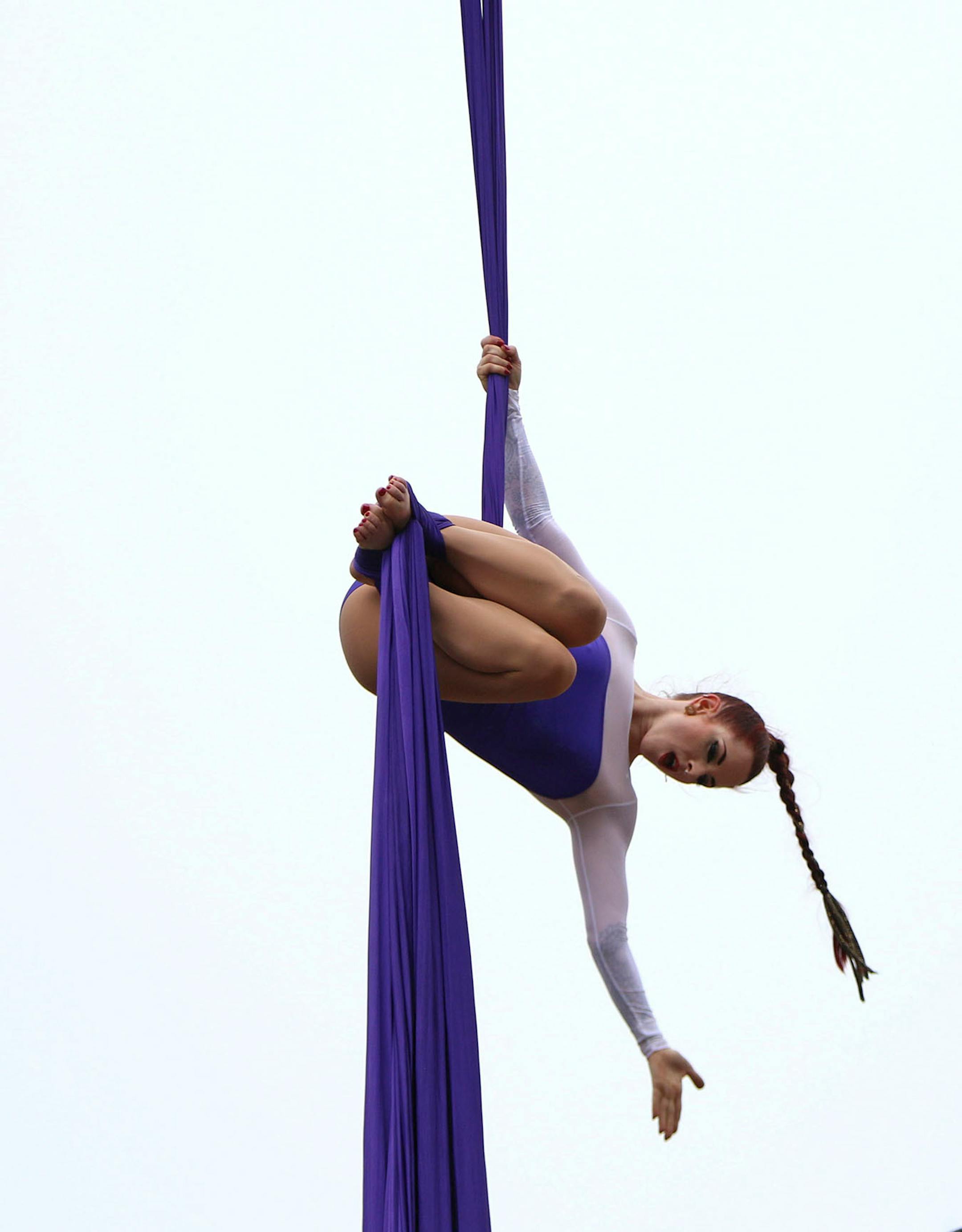 A performer dances on a sheet hanging from a billboard suspended above the pride parade on Sunday.