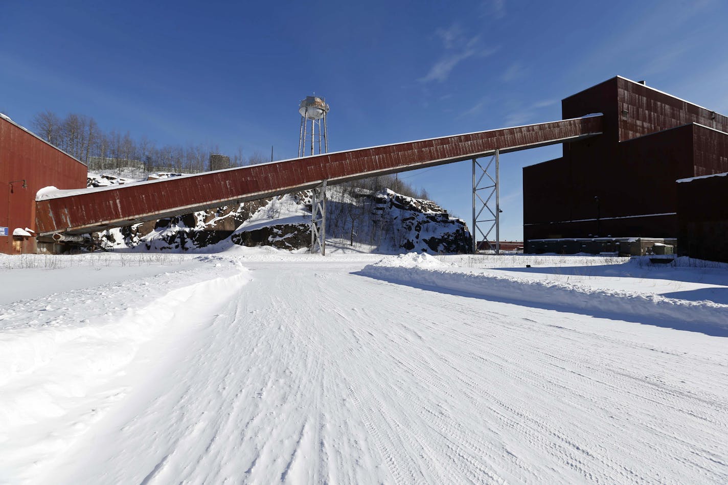 FILE - This Feb. 10, 2016, file photo shows a former iron ore processing plant near Hoyt Lakes, Minn., that would become part of a proposed PolyMet copper-nickel mine. Two public meetings are scheduled for Wednesday, Feb. 7, 2018, in Aurora, Minn., and Thursday, Feb. 8 in Duluth, Minn., on key permits for the proposed mine in northeastern Minnesota. (AP Photo/Jim Mone, File)