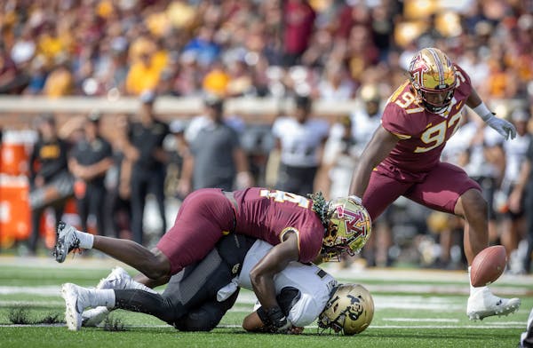 Gophers defensive back Terell Smith (4) sacked Colorado’s J.T. Shrout, and Jalen Logan-Redding (97) recovered the ball for a turnover early in last 