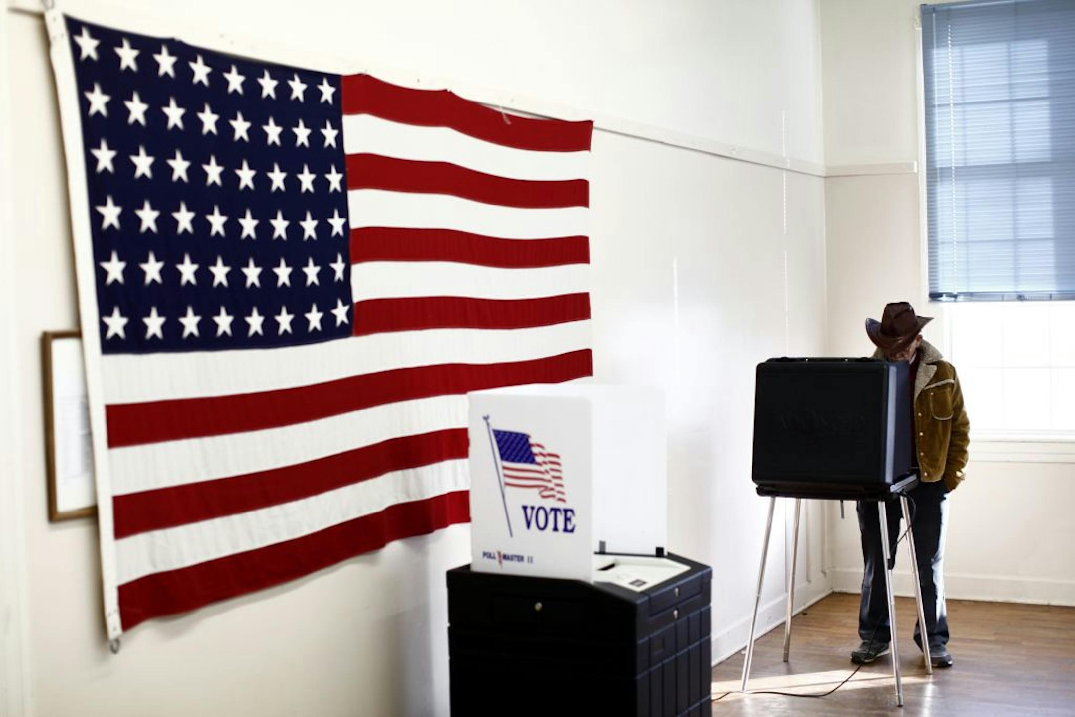 Darrell Lang casts his ballot in a polling station at the American Legion Post No. 17 in Shipman, Va., March 6, 2012. Republicans cast their votes in 10 states on Tuesday to help decide how to award the biggest batch of delegates so far in the party's presidential nominating contest, with Mitt Romney and Rick Santorum engaged in a particularly competitive fight in Ohio.