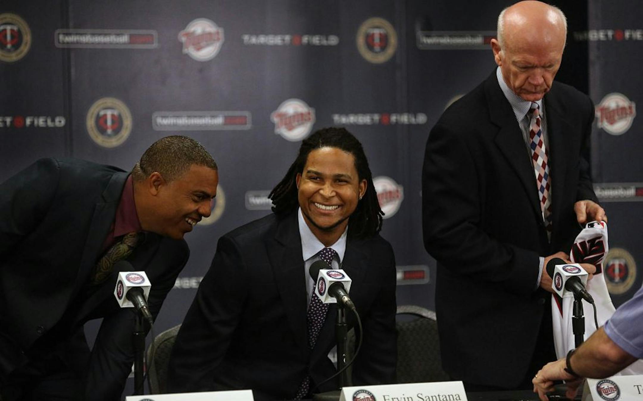 New Minnesota Twins pitcher Ervin Santana and his agent, Jay Alou (left), were all smiles as the press conference began. Twins general manager Terry Ryan is at right.