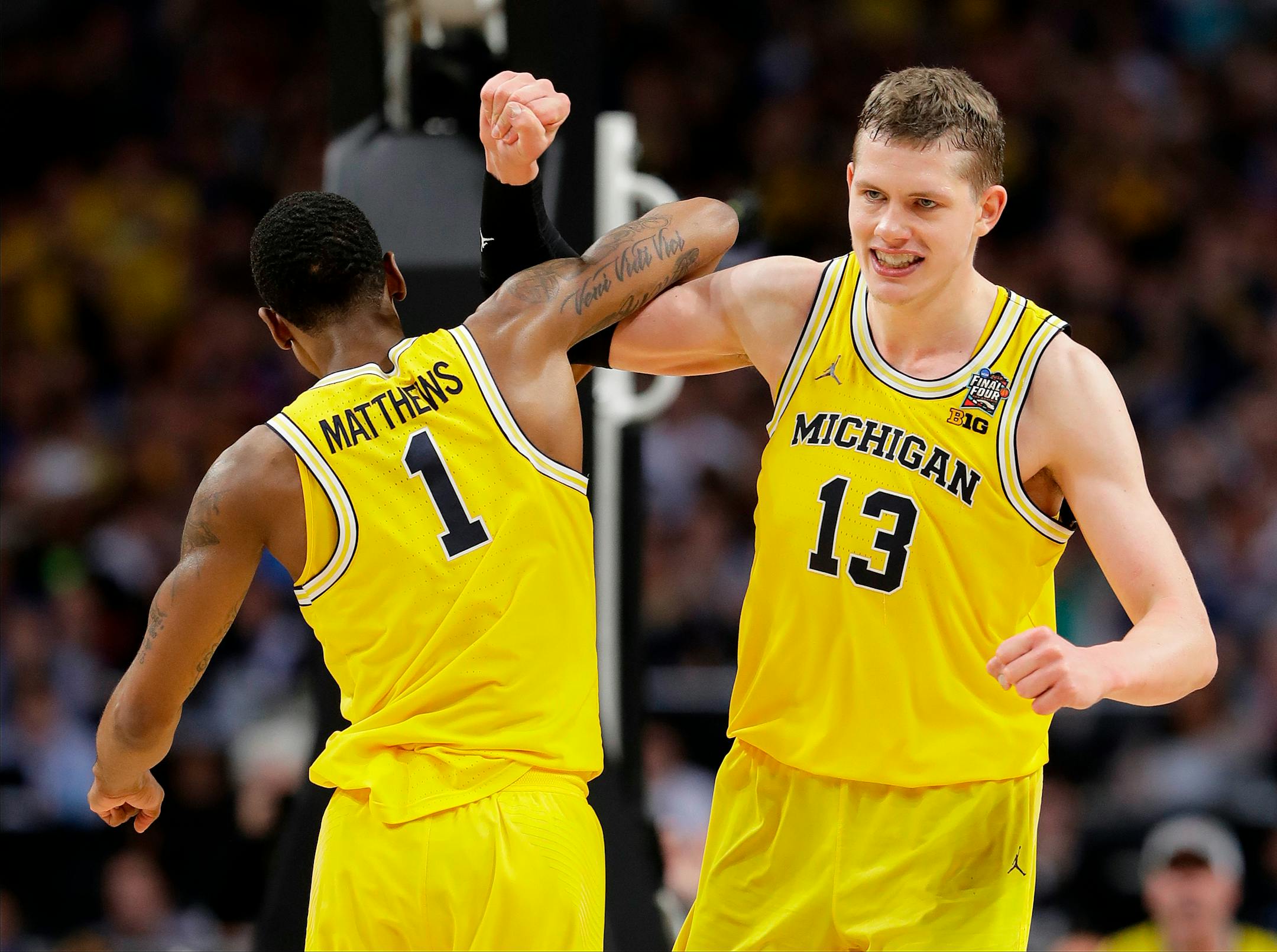 Michigan's Moritz Wagner (13) celebrates with Charles Matthews (1) during the second half in the semifinals of the Final Four NCAA college basketball tournament against Loyola-Chicago, Saturday, March 31, 2018, in San Antonio. (AP Photo/Eric Gay)