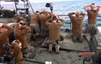 This picture released by the Iranian state-run IRIB News Agency on Wednesday, Jan. 13, 2016, shows detention of American Navy sailors by the Iranian R