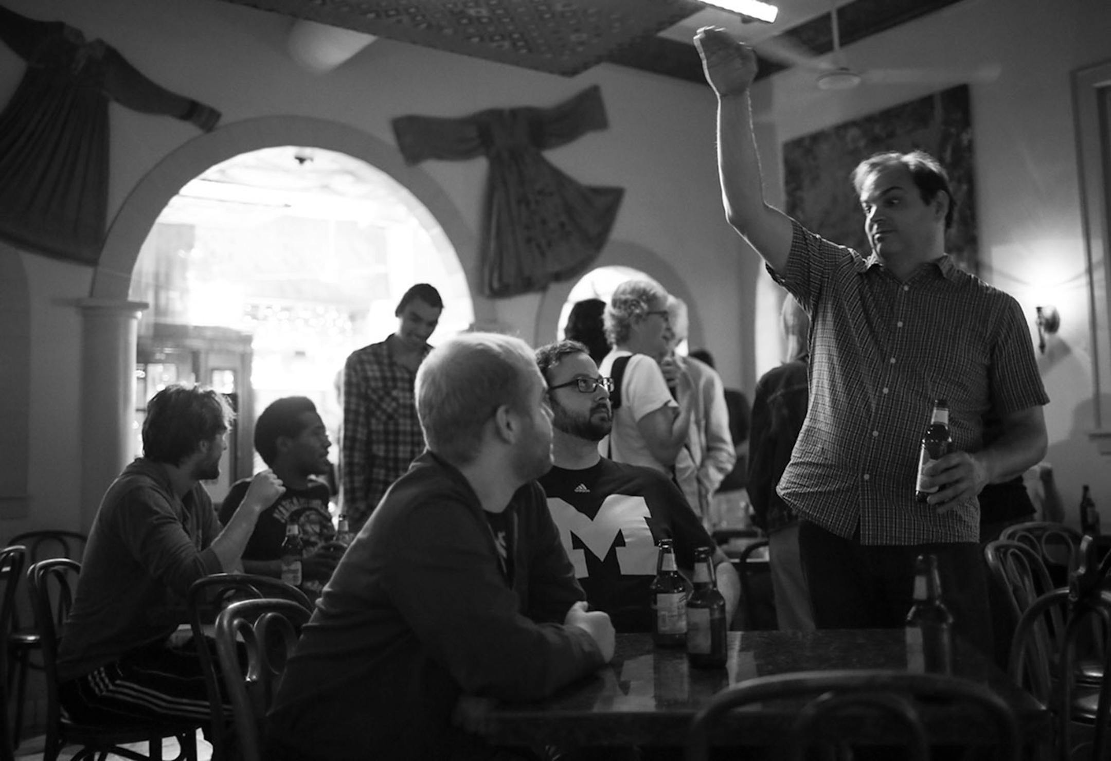 Bassist Chris Bates, standing, visited with patrons between jazz sets at Khyber Pass earlier this month.