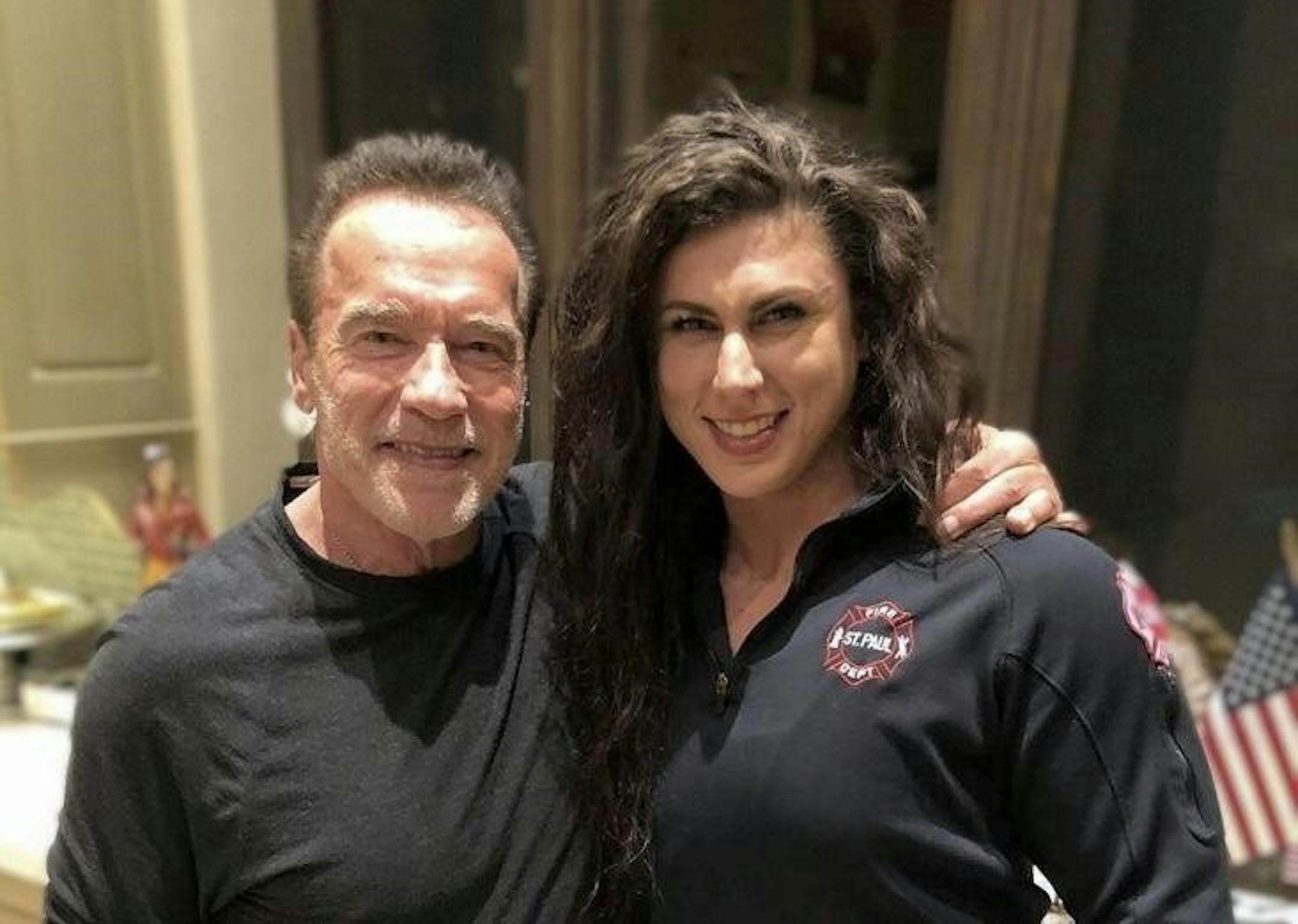 Arnold Schwarzenegger, host of the World's Strongest Firefighter contest, poses with St. Paul firefighter Sarah Reasoner