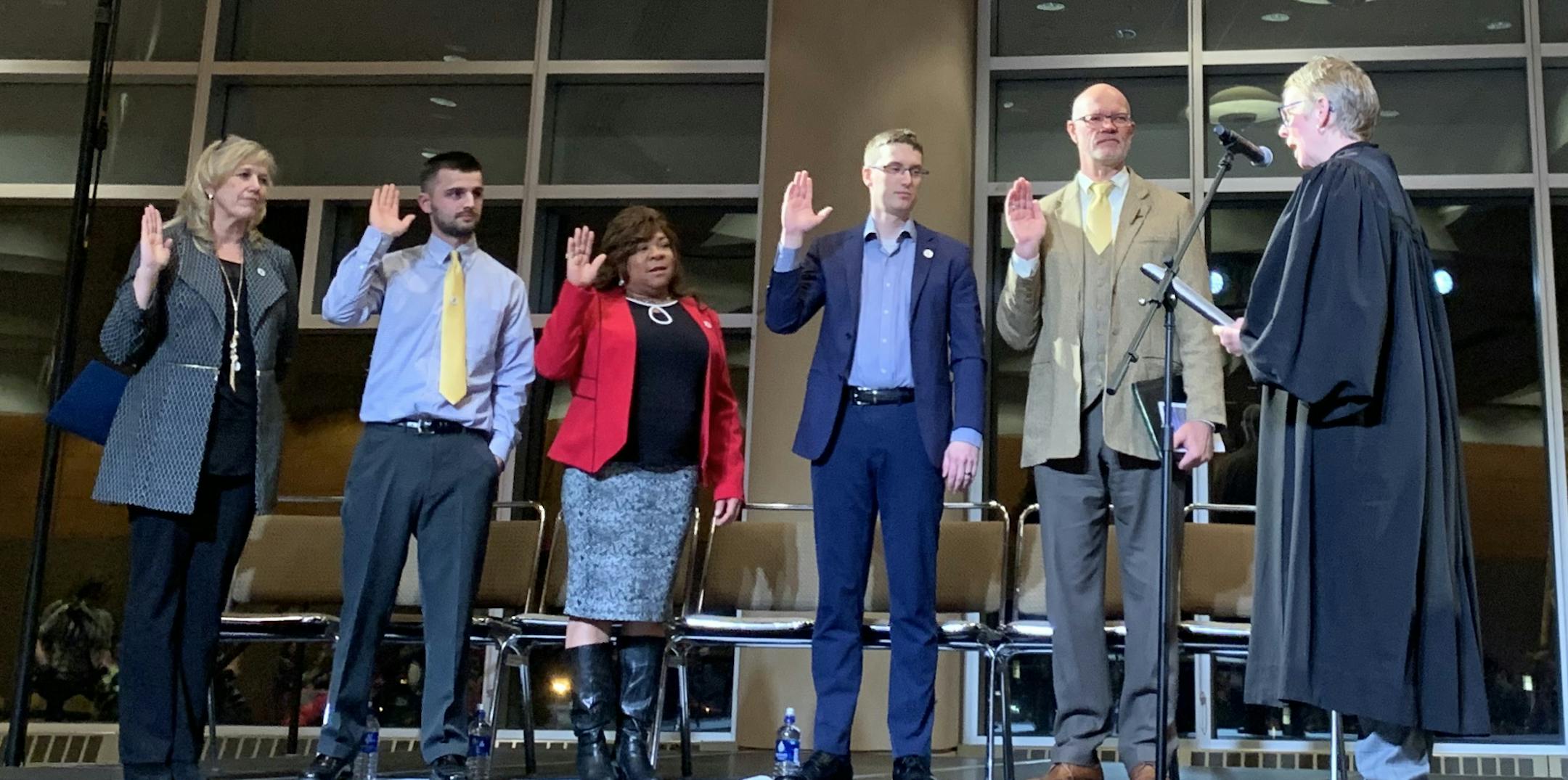 From left to right, Roz Randorf, Derek Medved, Janet Kennedy, Arik Forsman and Gary Anderson are sworn in as members of DuluthÕs City Council. Photo by Katie Galioto