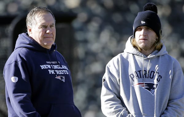 New England Patriots head coach Bill Belichick, left, watches his players along with his son, safeties coach Steve Belichick, during NFL football prac