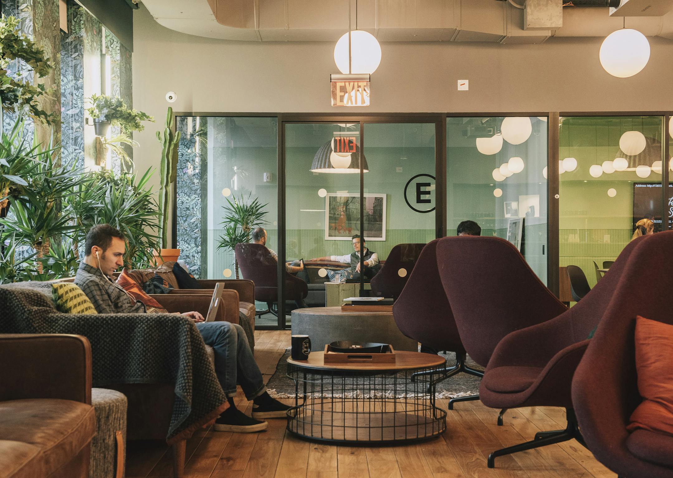 FILE -- People in a WeWork common space in New York, Jan. 22, 2018. WeWork, a real estate firm that leases shared office space, officially set in motion on Aug. 14, 2019, the process of becoming a publicly traded company by filing a financial prospectus with regulators. (Cole Wilson/The New York Times)