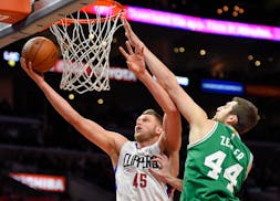 Los Angeles Clippers center Cole Aldrich, left, shoots as Boston Celtics center Tyler Zeller defends during the second half of an NBA basketball game,