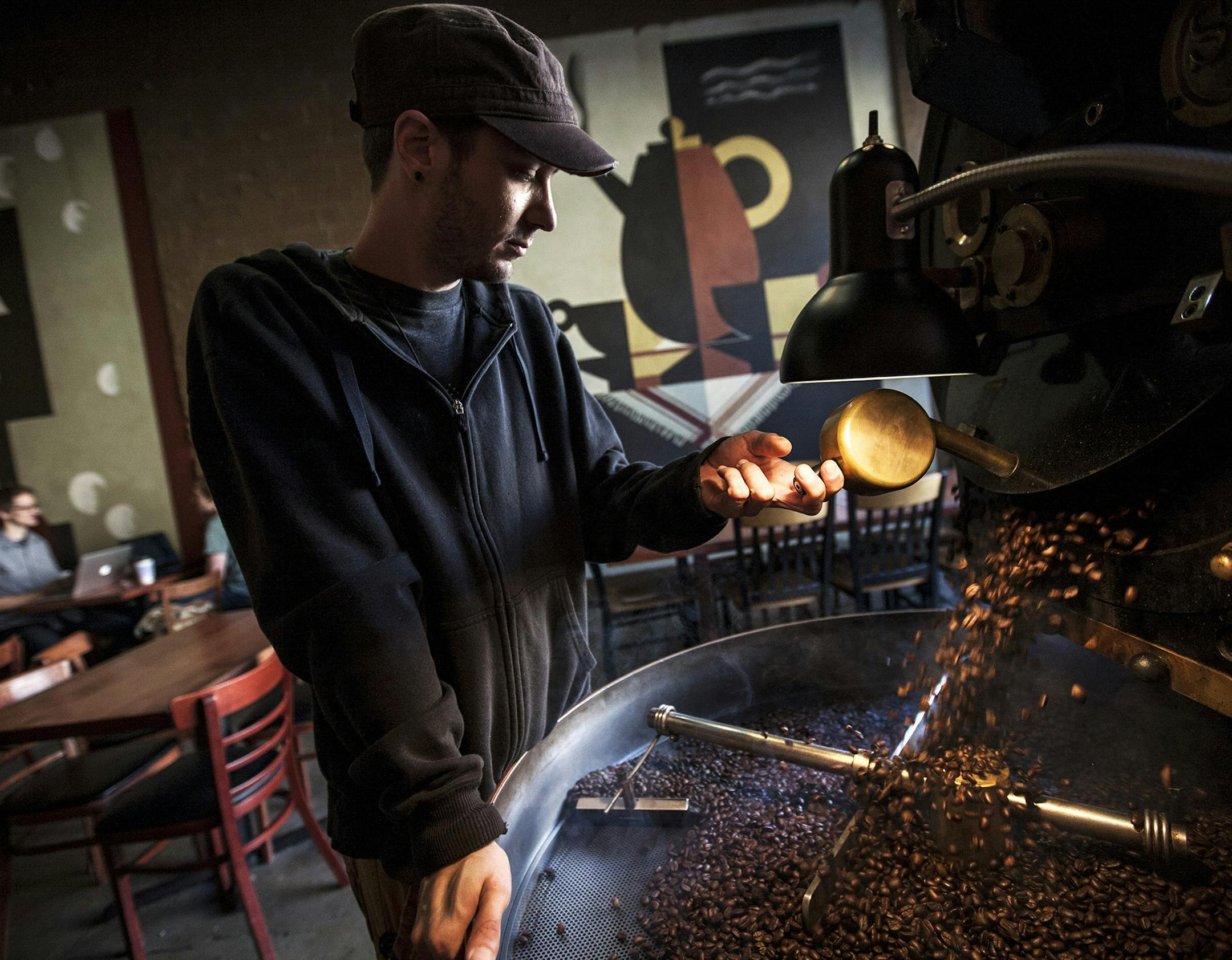 Paul Beach, 28, works at a coffee shop and doesn't have insurance because, as he said, "I'd rather eat than buy insurance." Beach roasts beans at the Dunn Bros Coffee where he has worked for over 5 years in Minneapolis September 13, 2013. (Courtney Perry/Special to the Star Tribune)