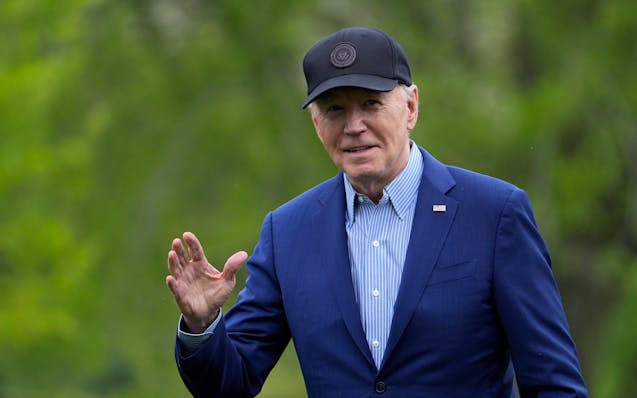 President Joe Biden waves as he walks across the South Lawn of the White House in Washington, Wednesday, April 17, 2024, after returning from a trip t