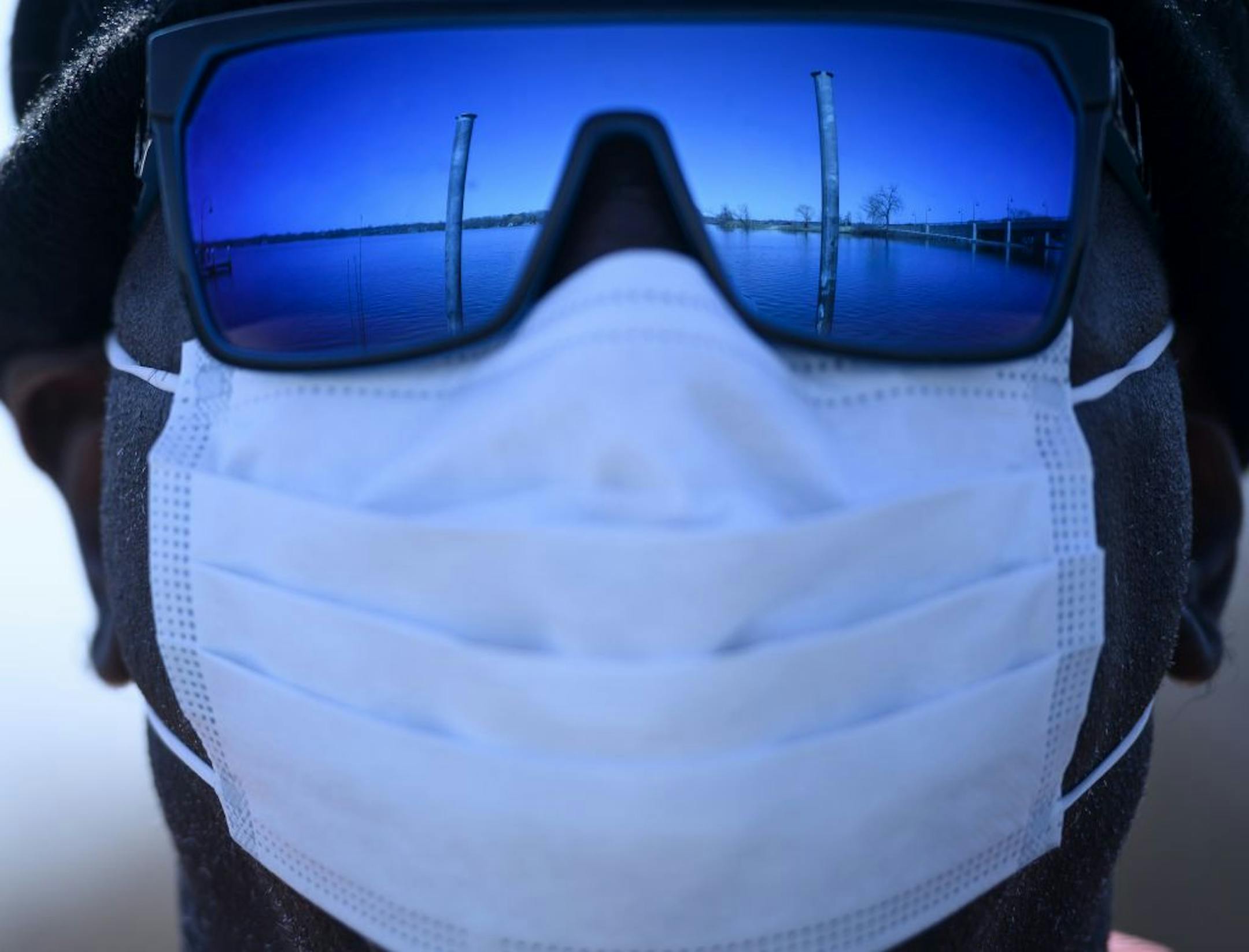 Lake Minnetonka was reflected in the glasses of Mike Kirby, of Brooklyn Park, as he stood on the docks at the Gray's Bay Boat Launch while waiting for his friend to check out a boat for sale Saturday.