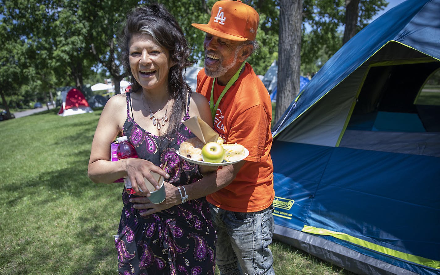 Carlos Lozano Enrique gave his girlfriend Marlo Benjamin a hug as he promised to someday marry her just outside a tent they share at Powderhorn Park, Friday, June 12, 2020 in Minneapolis, MN. Benjamin had been living with a friend at the Sheraton Hotel. ] ELIZABETH FLORES • liz.flores@startribune.com