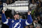 Tampa Bay Lightning defenseman Ryan McDonagh hoists the Stanley Cup after getting the win over the Montreal Canadiens in Game 5 of the NHL hockey Stan