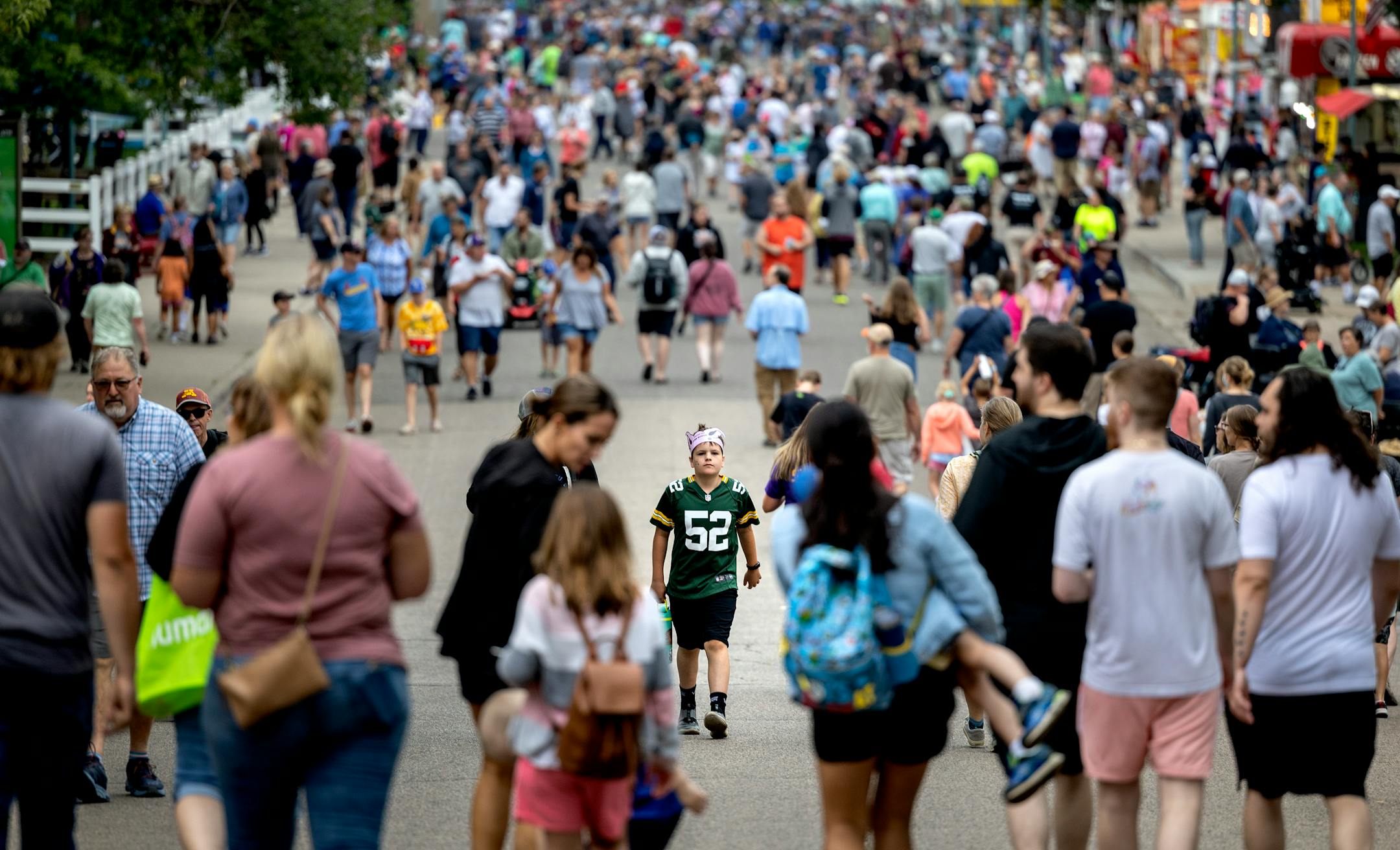Greyson DeWalt, 11, of Roseville (middle in Green Bay Packers jersey) made his way through the crowd Thursday,. August 25, 2022, at The Minnesota State Fair in Falcon Heights, Minn. ] CARLOS GONZALEZ • carlos.gonzalez@startribune.com