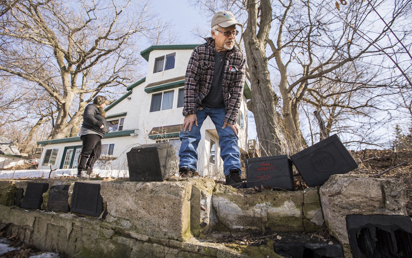 Bernie Brown looks at the car battery casings revealed in the crumbling foundation of an old structure near his home. His home's foundation was built the same way. ] LEILA NAVIDI &#xef; leila.navidi@startribune.com BACKGROUND INFORMATION: Bernie Brown knew the old, dilapidated lakeshore property in White Bear Lake would be a major undertaking when he bought it in 1993. Its biggest quirk? The home, built in the 1930s, has a foundation made up of car battery casings entombed in crumbling concrete.