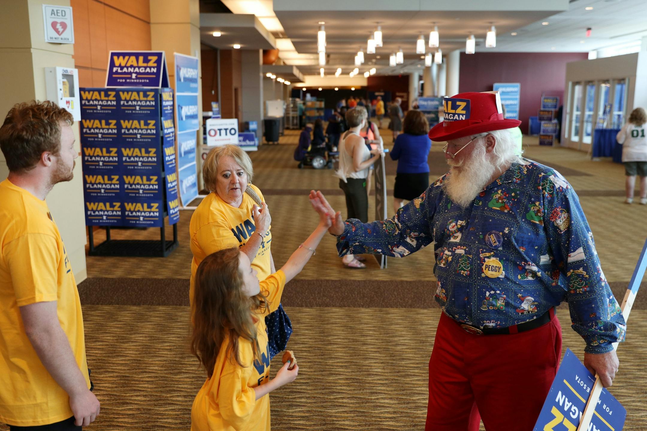 Tim Walz supporter Vern Wagner of Minneapolis gave a high five to Dani Jeffers, 10, Chatfield during the DFL State Convention Friday.