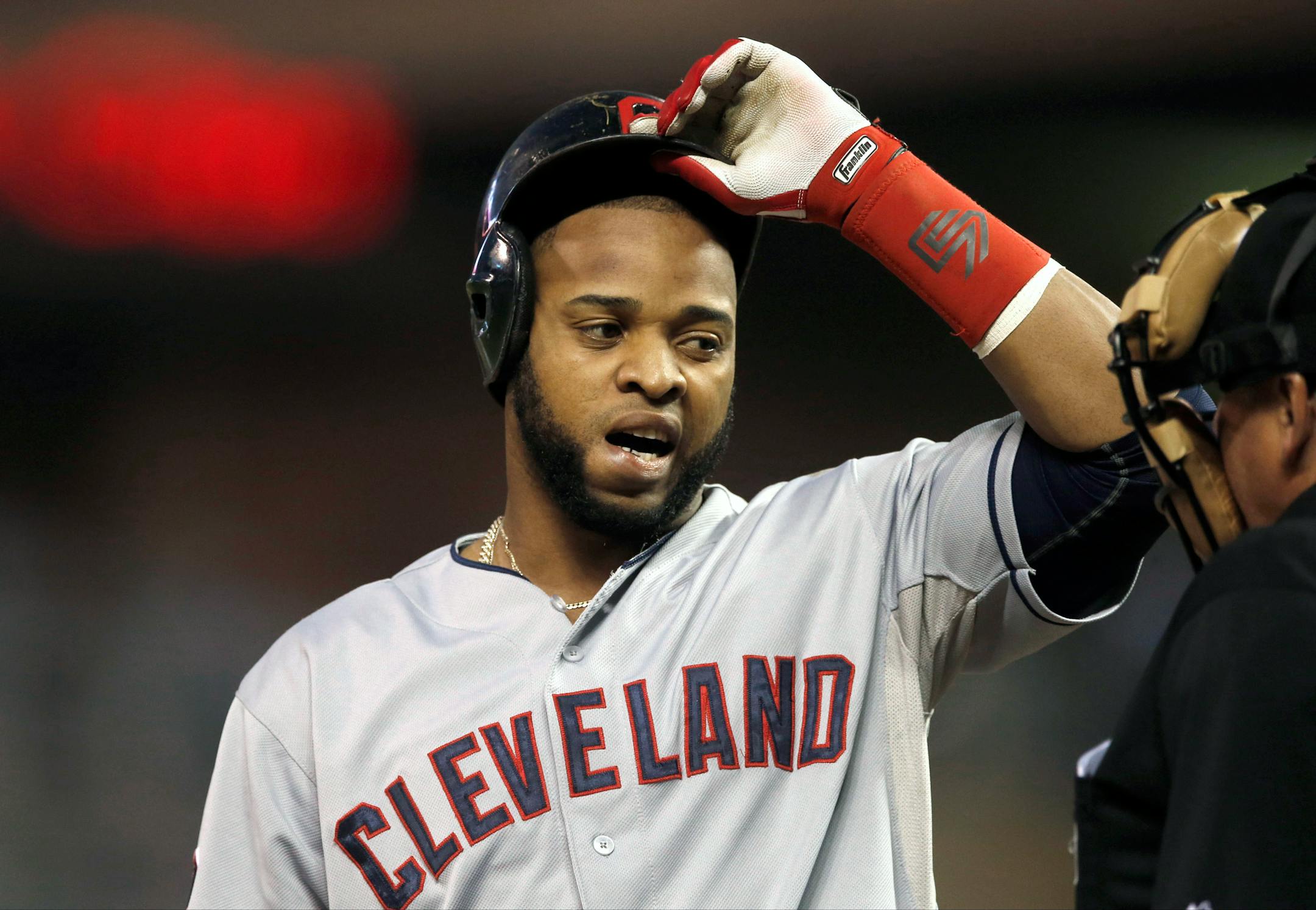 Cleveland Indians� Carlos Santana has a chat with plate umpire Tom Hallion after he struck out looking in the first inning of a baseball game against the Minnesota Twins, Tuesday, Sept. 22, 2015, in Minneapolis (AP Photo/Jim Mone)