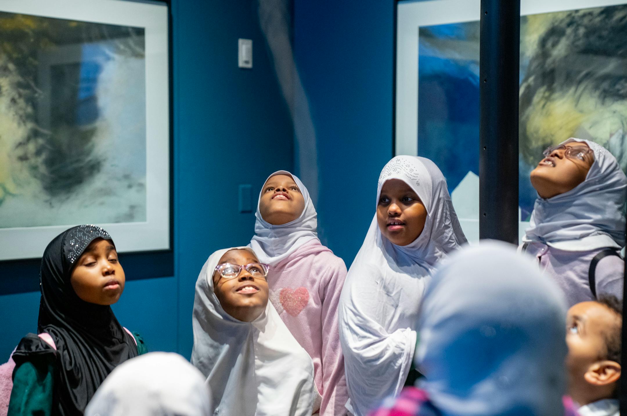 Children on a school trip checkout a miniature tornado exhibit.
