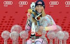 Lindsey Vonn poses in 2010 with Olympic medals and Women's World Cup skiing trophies