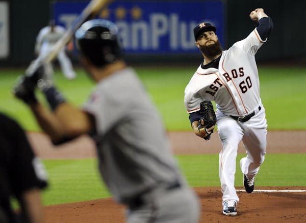 Astros starter Dallas Keuchel pitched to the Twins' Joe Mauer in the first inning Sunday.