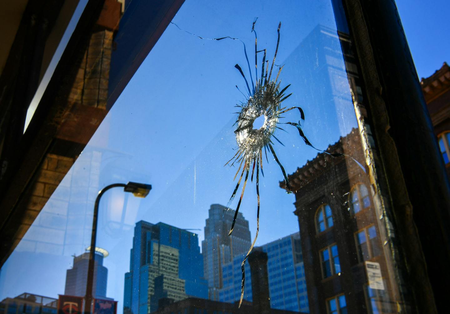 Two bullet holes in the glass of Jumpwings Heritage Brands Clothing store at 28 N 4th St right across the street from a police station. ] GLEN STUBBE * gstubbe@startribune.com Monday, October 3, 2016 As many as 6 people were shot early Monday in downtown Minneapolis, police said. Army surplus store at corner of 4th and Hennepin has bullet holes in window.