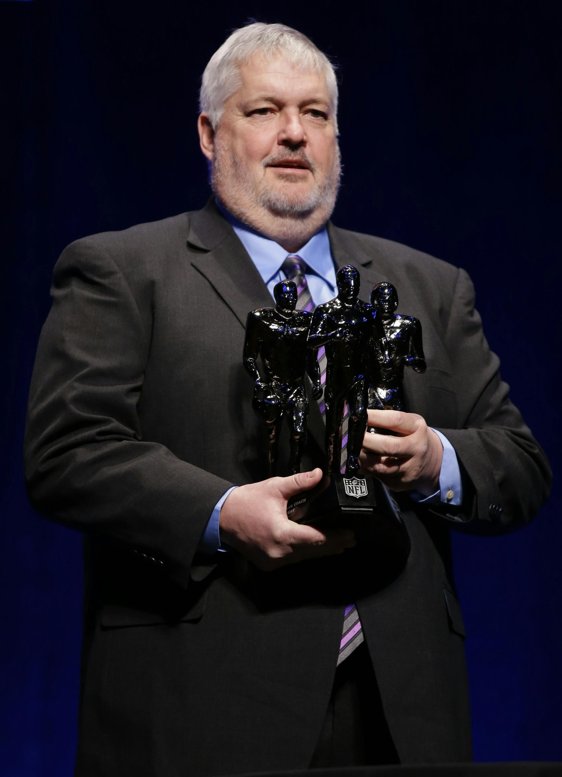 Eden Prairie High School Head Football Coach Mike Grant holds his trophy after he was named the Don Shula NFL High School Coach of the Year at a news conference Friday, Jan. 31, 2014, in New York prior to the NFL Super Bowl XLVIII football game between the Denver Broncos and the Seattle Seahawks on Sunday, Feb. 2, at MetLife Stadium in East Rutherford, N.J. (AP Photo/Matt Slocum)