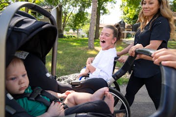 Marrie Bottelson, a plaintiff in the lawsuit, went for a walk with roommate and caregiver Ila Unga and Unga’s two sons. 