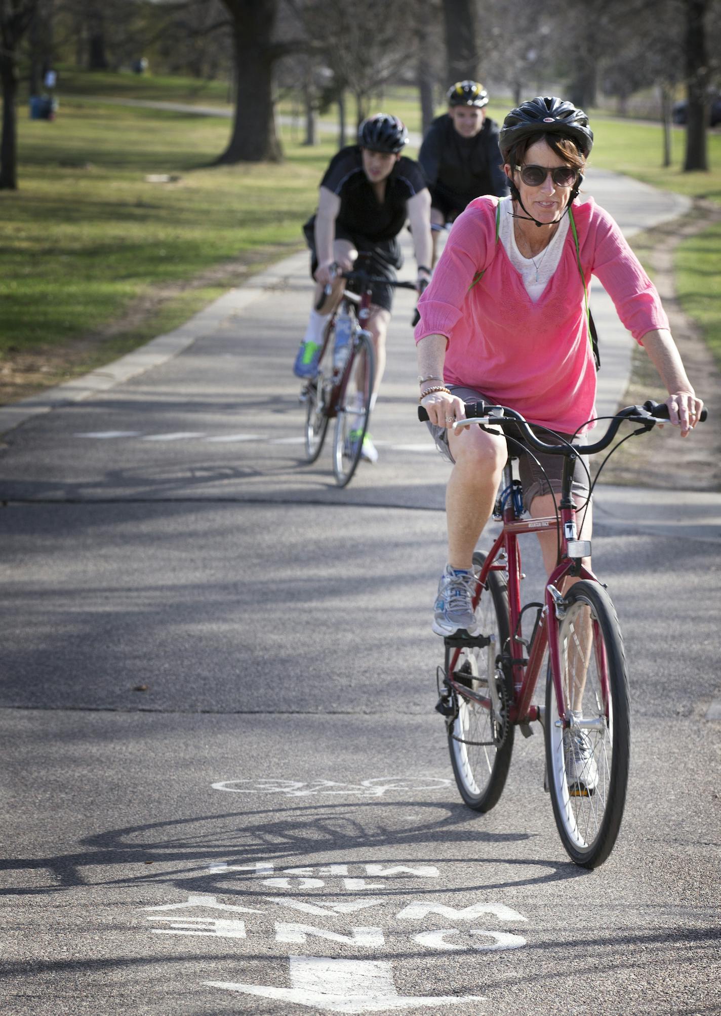 Bicyclists ride along the bike path around Lake Calhoun in Minneapolis on Wednesday, April 15, 2015. ] LEILA NAVIDI leila.navidi@startribune.com / BACKGROUND INFORMATION: City park officials are debating doing away with the bicycle speed limit of 10 mph, saying they are not enforceable.