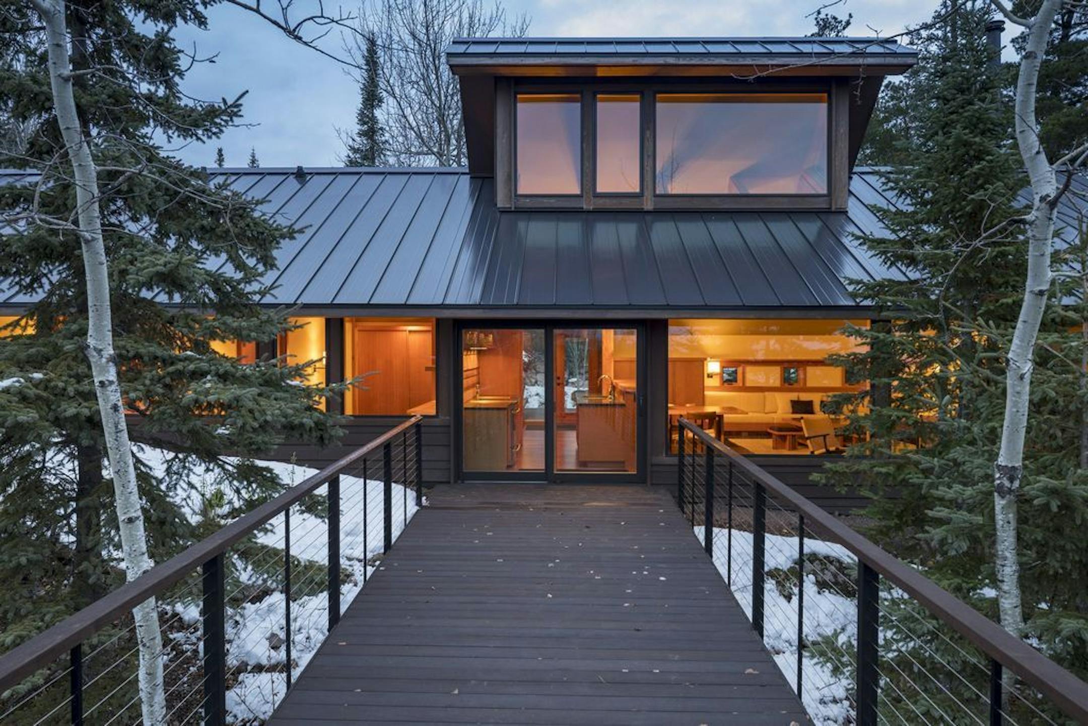The North Shore retreat designed by SALA Architects, is nestled among rock outcroppings on Lake Superior's Crystal Bay. The ipe deck and steel railing "bird walk" is on the lake side.