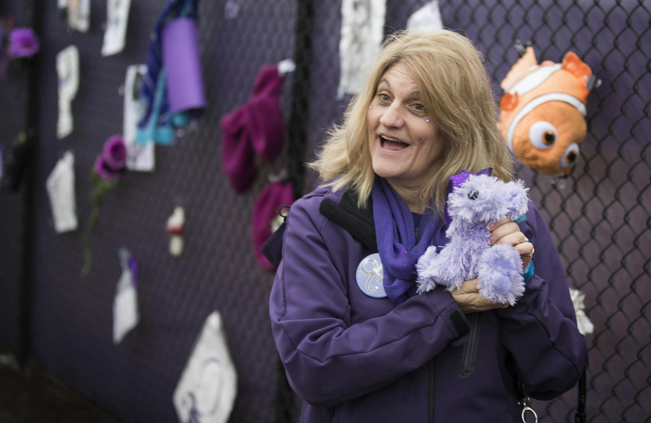 Anna Horn of West St. Paul poses for a photo with a stuffed animal she is leaving on the "Prince4Ever" fence. ] LEILA NAVIDI &#xef; leila.navidi@startribune.com BACKGROUND INFORMATION: Fans visit the &#xec;Prince4Ever&#xee; tribute fence located inside Paisley Park on Monday, April 3, 2017. The fence will be open to the public for two days this month, April 3 and April 10 from 9 a.m. to 9 p.m., free of charge for fans to leave memorial items.