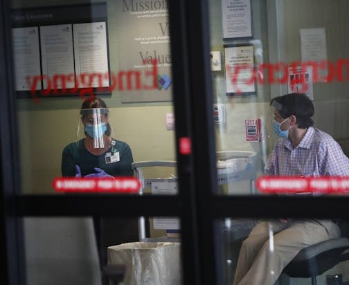 Screeners waited at Park Nicollet Methodist Hospital emergency room, where they checked patients for COVID symptoms, in St. Louis Park on June 4.