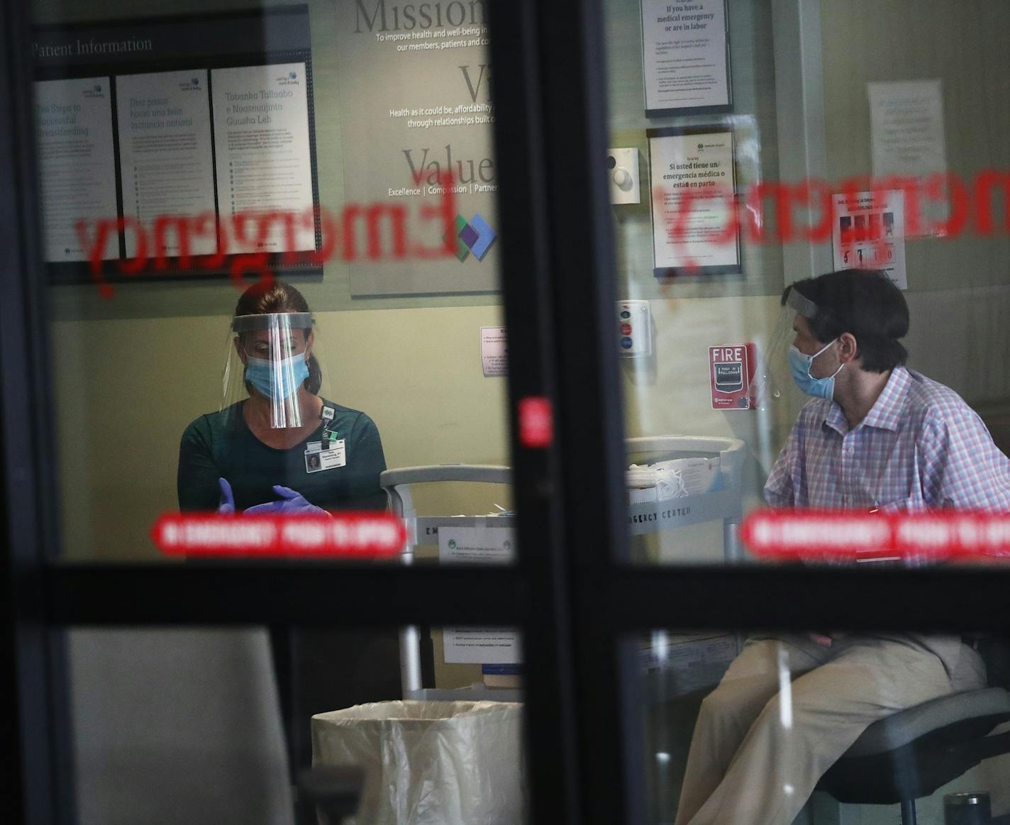 Screeners waited at Park Nicollet Methodist Hospital emergency room, where they checked patients for COVID symptoms, in St. Louis Park on June 4.