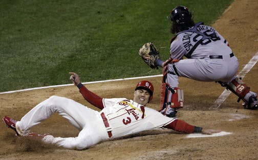 St. Louis Cardinals' Carlos Beltran slides safely past Boston Red Sox catcher Jarrod Saltalamacchia during the seventh inning of Game 3 of baseball's World Series Saturday, Oct. 26, 2013, in St. Louis. Beltran scored from second on a double by Matt Holliday. (AP Photo/David J. Phillip)