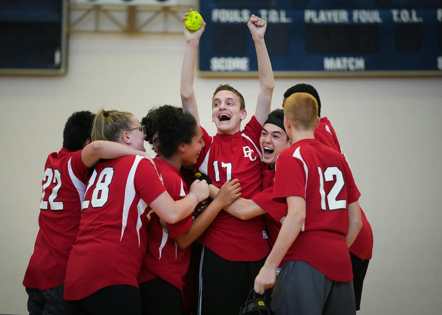 JT Koczur (17) is swarmed by his Blazing Cats teammates after catching a fly ball in the 11th inning to win the game 7-5 over the Dakota United Hawks in the CI division of the Minnesota State High School League Adapted Softball Championship at the Chanhassen High School gym in Chanhassen, Minn., on Saturday, June 3, 2023. ] SHARI L. GROSS • shari.gross@startribune.com