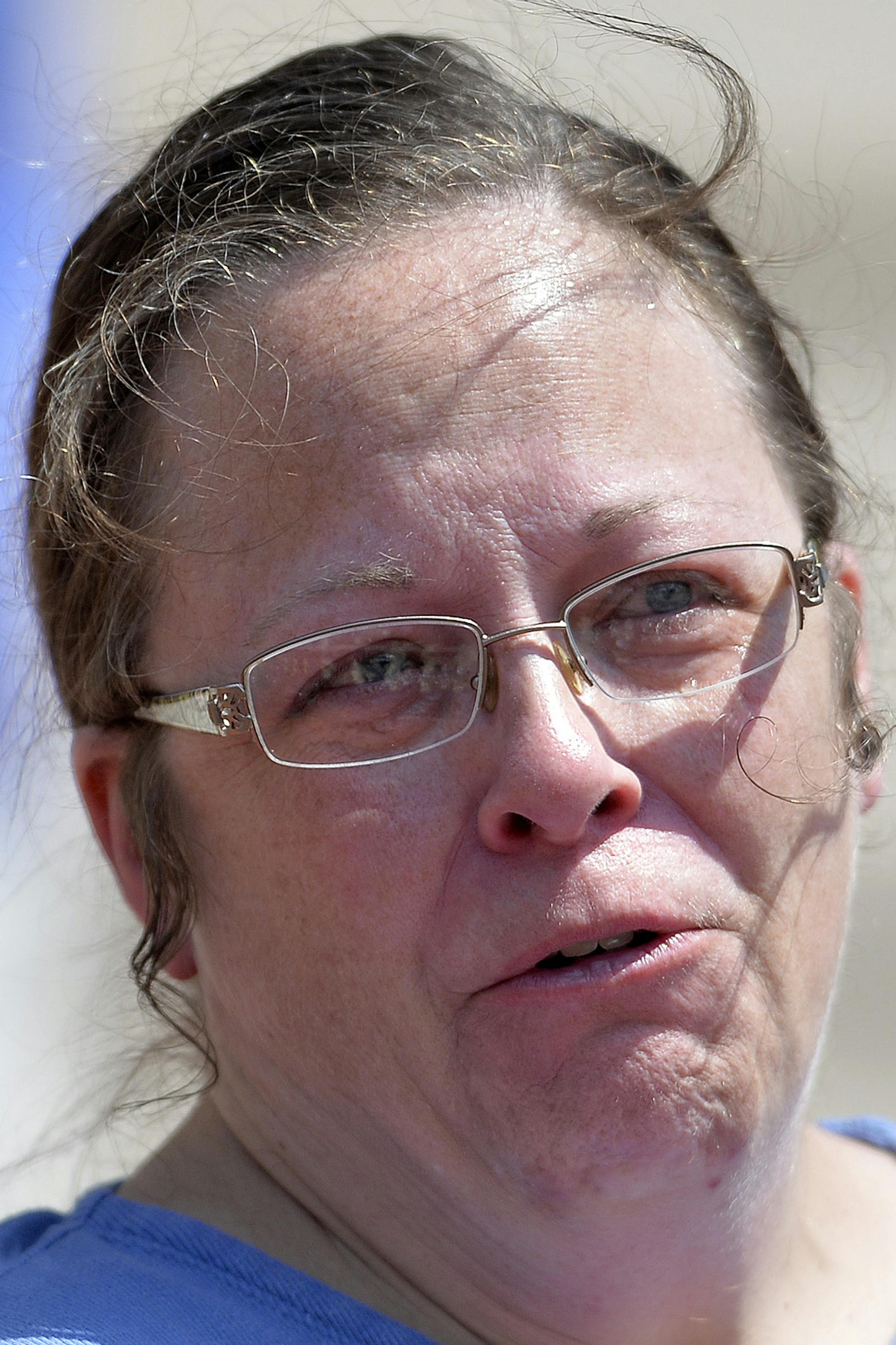 Rowan County Kentucky Clerk Kim Davis shows emotion as she is cheered by a gathering of supporters during a rally on the steps of the Kentucky State Capitol in Frankfort Ky., Saturday, Aug. 22, 2015. Davis spoke at the rally organized by The Family Foundation of Kentucky. The crowd of a few thousand included churchgoers from around the state. Davis has been sued by The American Civil Liberties Union for denying marriage licenses to gay couples. She says her Christian faith prohibits her from sig