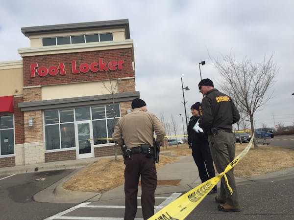 Police investigate Saturday after a shooting at a shopping center in Brooklyn Center.