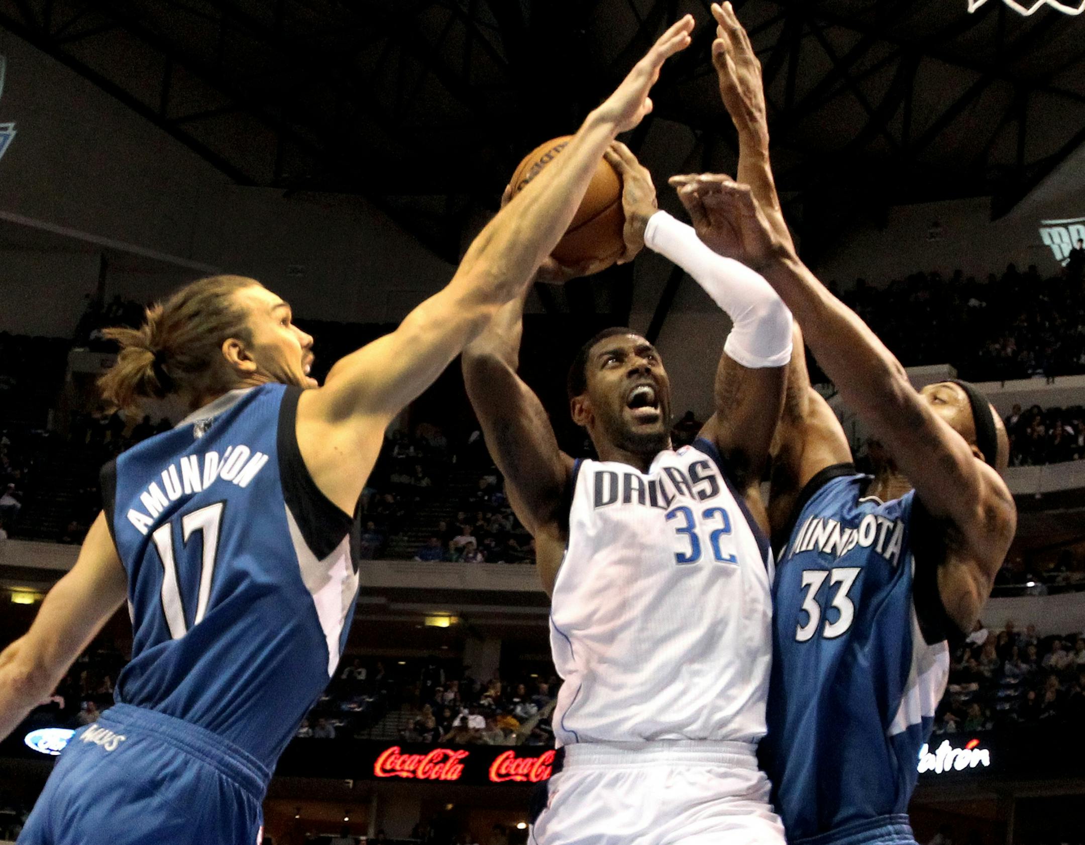 Dallas Mavericks' OJ Mayo (32) drives between Minnesota Timberwolves' Lou Amundson (17) and Dante Cunningham (33) in the second quarter at American Airlines Center in Dallas, Texas, on Monday, November 12, 2012.
