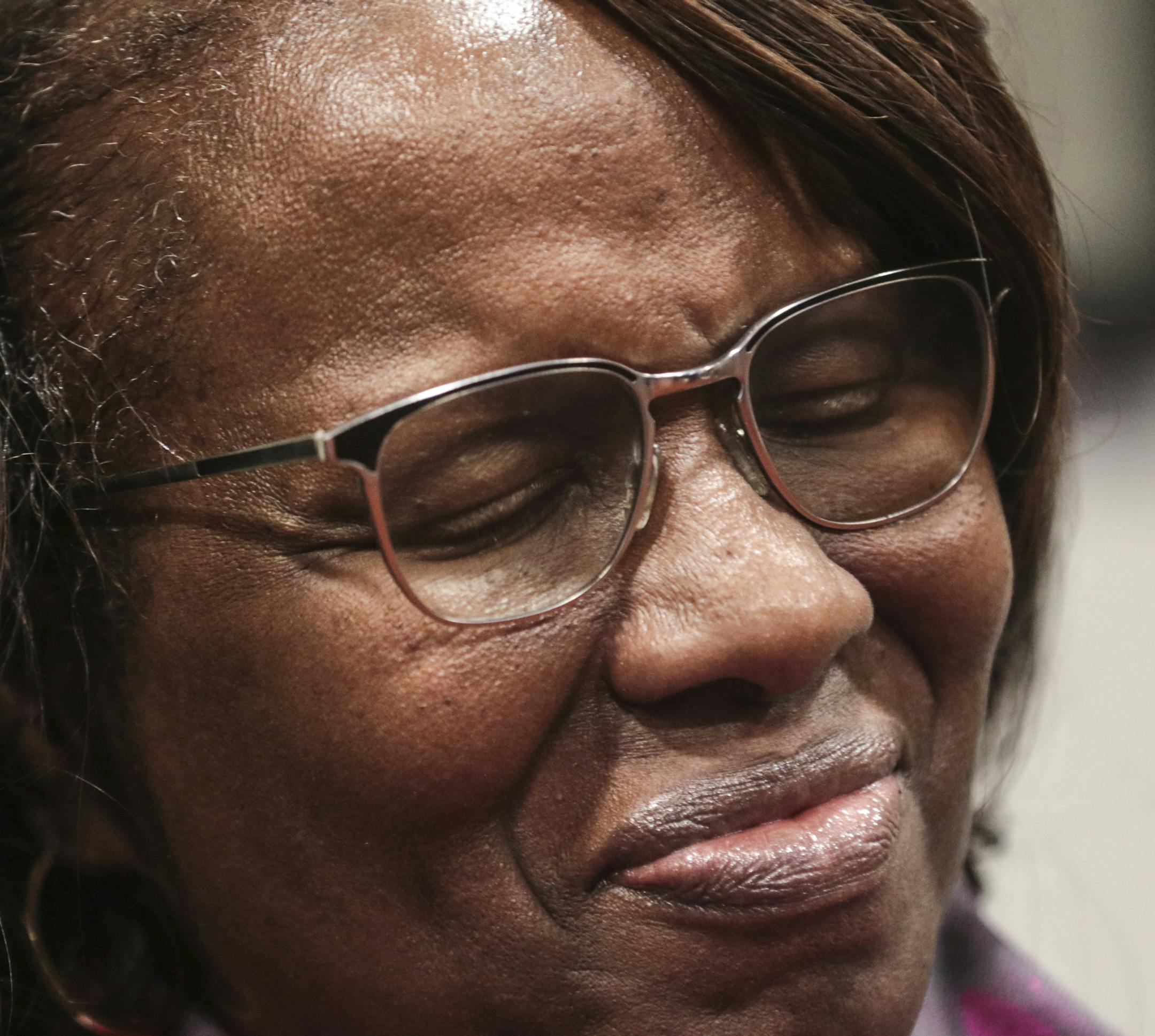 Felicia Sanders, who watched her son Tywanza Sanders die at the hands of Dylann Roof, smiles while speaking to media after Roof was found guilty of murdering nine parishioners at Emanuel AME Church in Charleston in a hate crime Friday, Dec. 15, 2016, in Charleston S.C. "I wear a smile now because the nine victims wore beautiful smiles in photos before they were killed," Sanders said. (Matt Walsh/The State via AP)