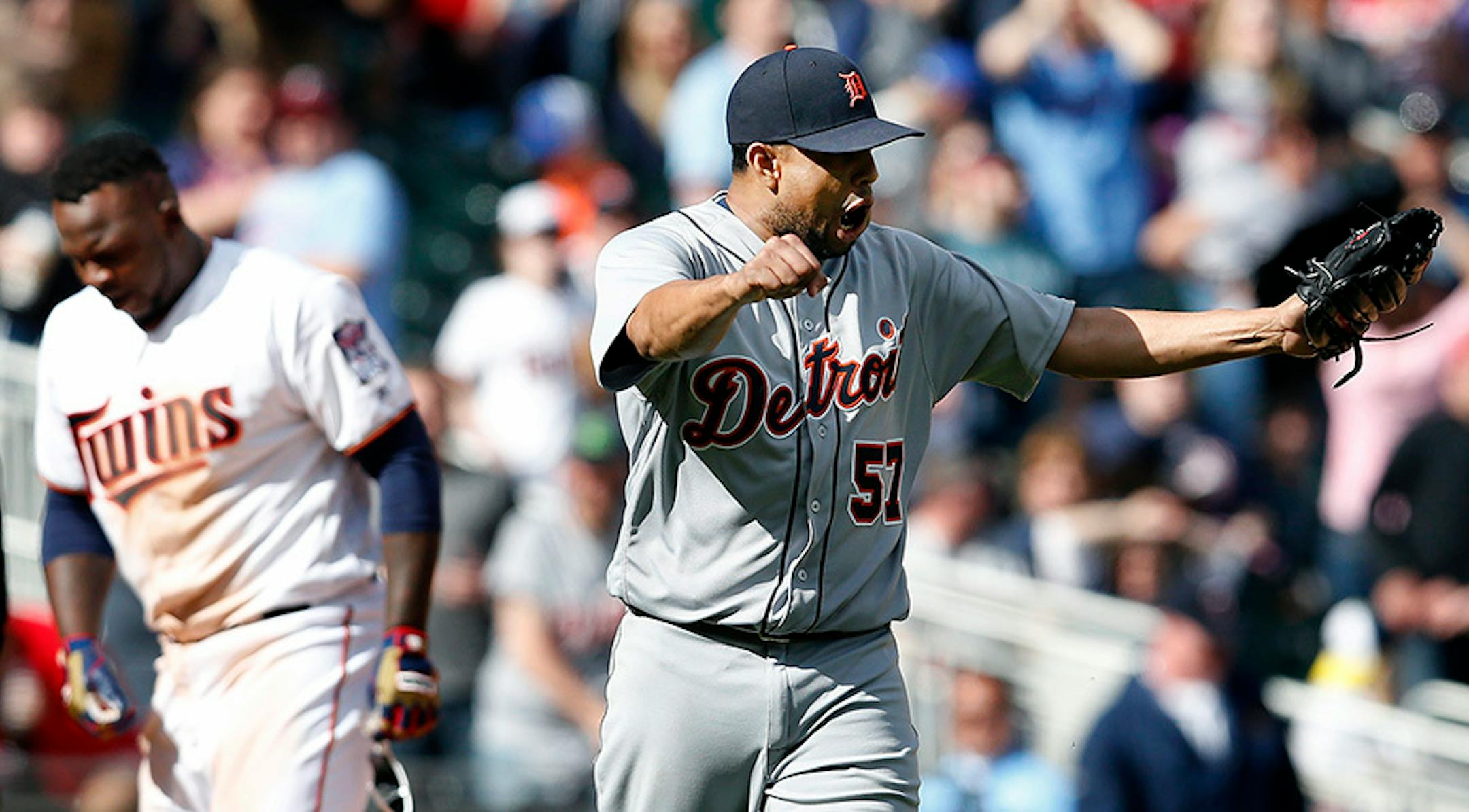 Tigers pitcher Francisco Rodriguez (57) celebrated after Miguel Sano was tagged out at third base by Mike Aviles (14) while attempting to extend a double into a triple in the ninth inning to end the game.