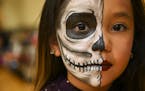 Khloe Flores-Lara, 8, stood for a portrait to show off her elaborate face-painting, done by her aunt, Kimberly Lara, at Saturday's Dia de los Muertos 