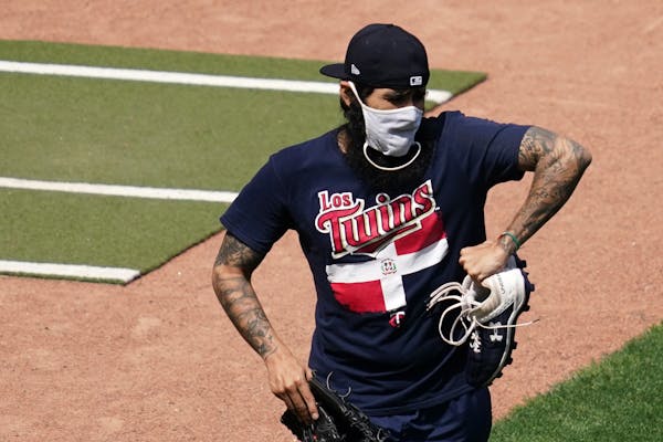 Twins relief pitcher Sergio Romo wore a mask as he took the field for practice Friday.