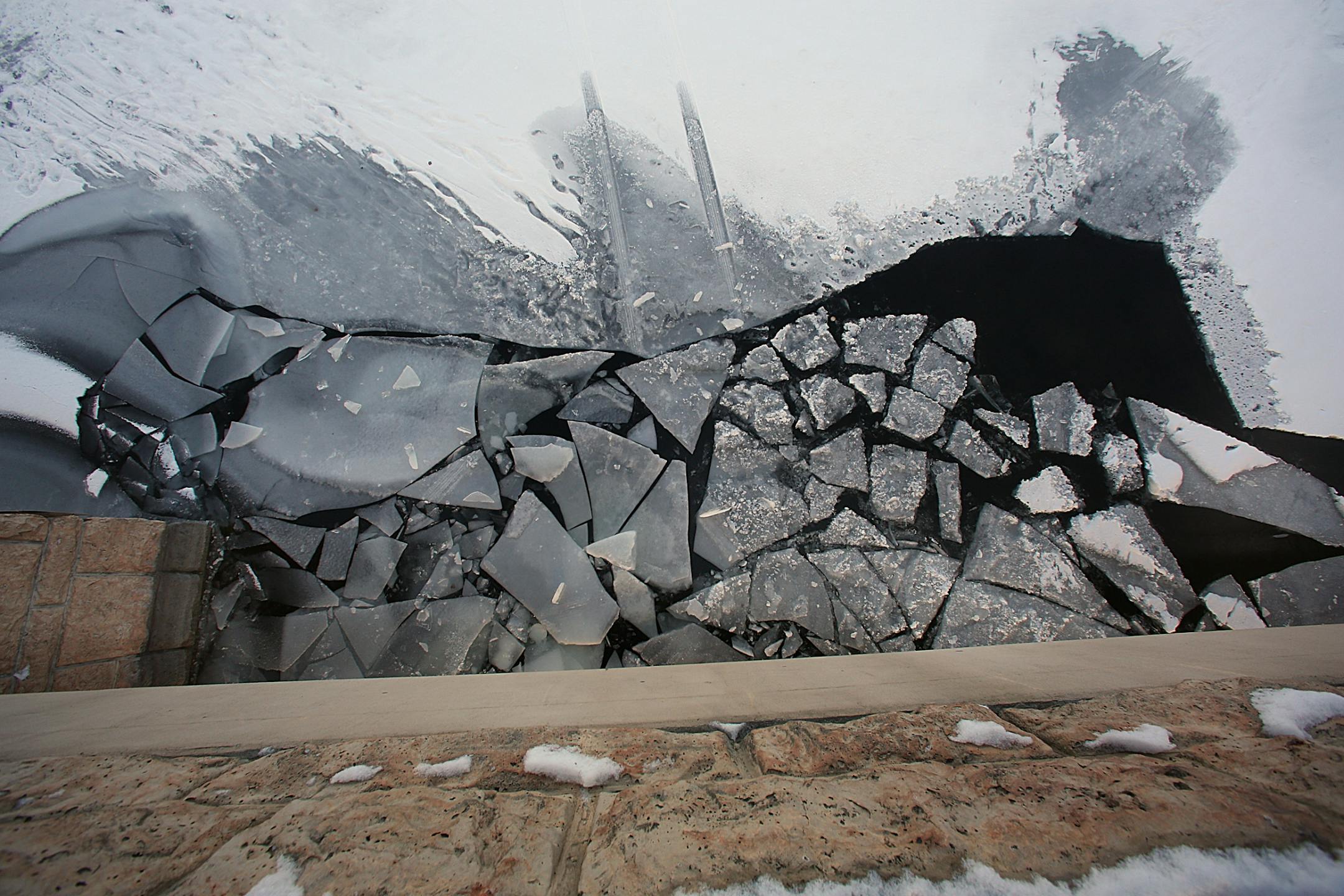 Broken ice and tire tracks can be seen from the Hwy. 101 bridge, where a vehicle broke through the ice Saturday afternoon.