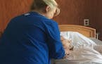 Hospice nurse Dee Metzger administers a painkiller and sedative to cancer patient Nancy Mattes, 68, at the David Simpson Hospice House, one of three i