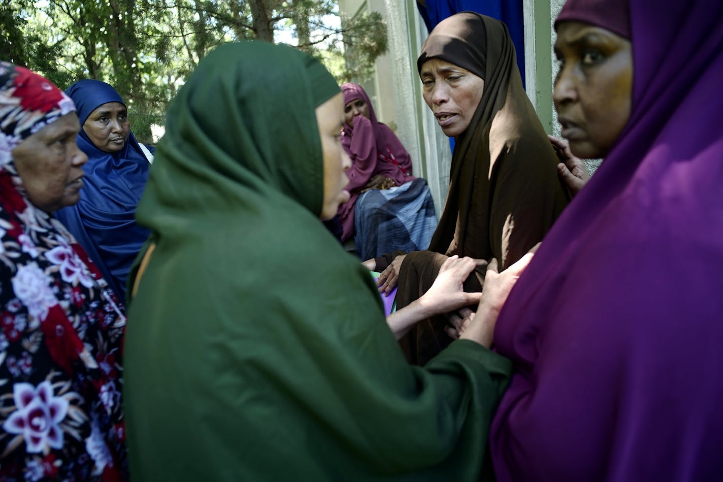 In Wilmar, second from right, Lul Mohamed grieved for her son Ahmed Ashi, 11 who drowned along with childhood friend Idris Hussein,11, at nearby Foot Lake near the dock. [ Richard Tsong-Taatarii/rtsong-taatarii@startribune.com